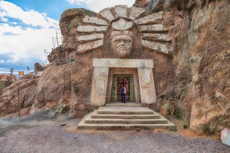 Photo for Cusco, Peru - September 24, 2022: La Morada De Los Dioses - Apukunaq Tianan (the abode of the gods), a tourist attraction in Cusco. Here a tourist in the entrance of the temple of the sun god. - Royalty Free Image
