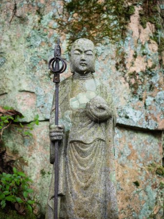Stone Jizo statue in the mountains of Hiroshima prefecture, Japan