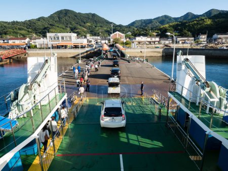 Photo for Hiroshima, Japan - August 24, 2018: Vehicles and passengers disembarking from a car ferry at Kirikushi port on Etajima Island in Seto Inland Sea - Royalty Free Image