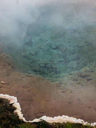 Steaming colorful hot spring pool in Geysir geothermal area, Iceland