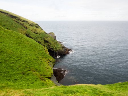 Dramatic cliffs of Storhofdi peninsula at the southernmost end of Heimaey Island - Westman Islands, Iceland
