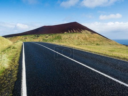 Scenic road with view of Helgafell volcano on Heimaey Island - Westman Islands, Iceland