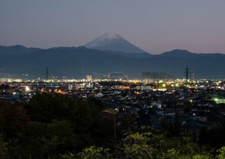 Photo for Nighttime view of Kofu city with Mount Fuji on the background - Yamanashi prefecture, Japan - Royalty Free Image