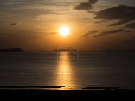 Sun setting over Seto Inland Sea at Ariakehama beach - Kanonji, Kagawa prefecture, Japan
