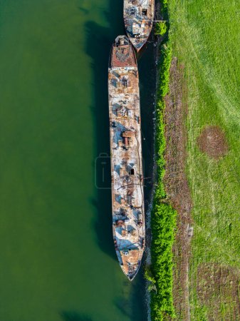 Aerial view of abandoned and forsaken Sava river ships, anchored on the eastern side of Zagreb city, Croatia