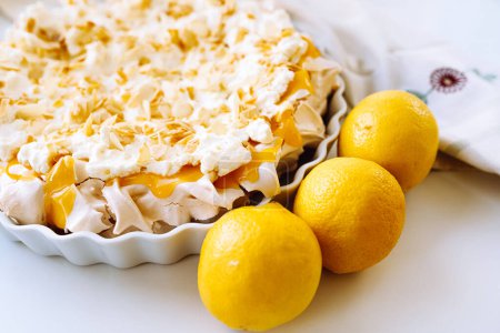 meringue with lemon curd. Protein dessert with whipped cream and bright yellow lemon curd close-up