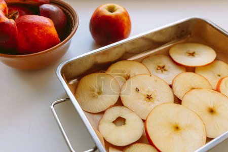 Téléchargez les photos : Plaque de cuisson aux pommes tranchées, préparée pour le séchage ou la cuisson. pose plate - en image libre de droit