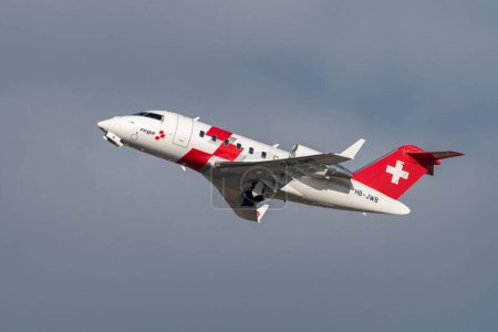 Foto de Zurich, Switzerland, January 19, 2023 REGA Swiss air rescue Bombardier Challenger 650 aircraft is taking off from runway 28 - Imagen libre de derechos