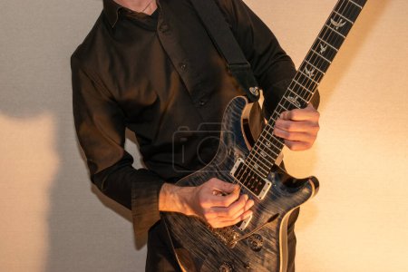 Photo for Vaduz, Liechtenstein, January 13, 2023 Musician is playing with a PRS Custom 24 electric guitar in blue - Royalty Free Image