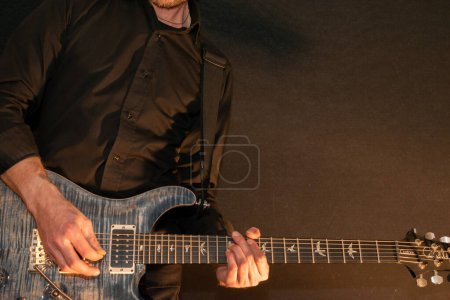 Photo for Vaduz, Liechtenstein, January 13, 2023 Musician is playing with a PRS Custom 24 electric guitar in blue - Royalty Free Image