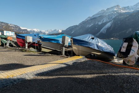 Téléchargez les photos : Brienz, Suisse, 10 février 2023 De petits bateaux sont couverts et entreposés sur la côte du lac de Brienz - en image libre de droit