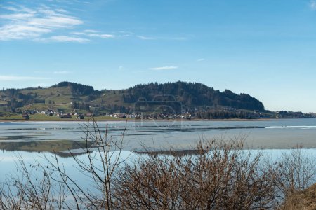 Photo for Einsiedeln area, Canton Schwyz, Switzerland, February 20, 2023 Beautiful view over the lake Sihlsee on a sunny day - Royalty Free Image