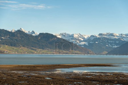 Photo for Einsiedeln area, Canton Schwyz, Switzerland, February 20, 2023 Fascinating view along the lake Sihlsee and the surrounding alpine landscape - Royalty Free Image