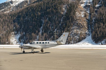Photo for Samedan, Switzerland, February 21, 2023 Cessna 425 Conquest multi engine propeller aircraft is taxiing to its position - Royalty Free Image