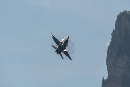 Photo for Mollis, Switzerland, August 18, 2023 Swiss military McDonnell Douglas F/A-18 hornet fighter is doing performances during an air display - Royalty Free Image