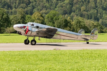 Foto de Mollis, Suiza, 18 de agosto de 2023 NC-18125 Lockheed Model 12 Electra Junior aircraft is taxiing on the runway - Imagen libre de derechos