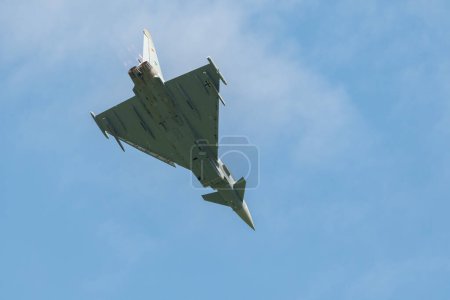 Photo for Mollis, Switzerland, August 18, 2023 Eurofighter Typhoon military jet is performing acrobatics during an air display - Royalty Free Image