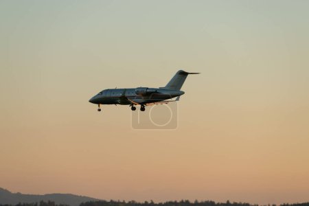 Photo for Zurich, Switzerland, September 6, 2023 9H-VFE Vista Jet Malta Bombardier Challenger 605 aircraft on its final approach to runway 14 in the evening - Royalty Free Image