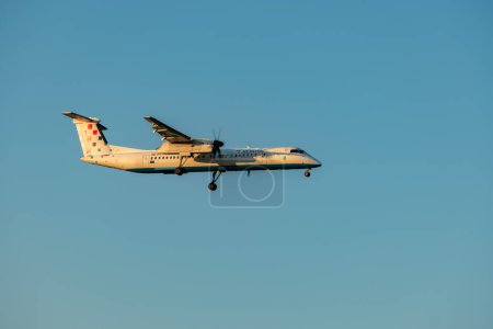 Photo for Zurich, Switzerland, September 6, 2023 9A-CQC Croatia Airlines De Havilland Canada Dash 8-400 propeller airplane on its final approach to runway 14 - Royalty Free Image