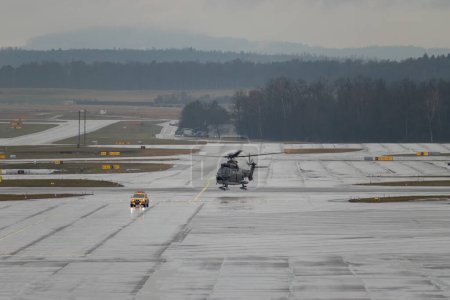 Photo for Zurich, Switzerland, January 17, 2024 Swiss Air Force Super Puma helicopter on the apron in the rain during the world economic forum in Davos - Royalty Free Image