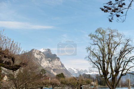 Weesen, Switzerland, March 22, 2024 Sunny day in spring time at the coast of the lake Walensee surrounded by the majestic swiss alps