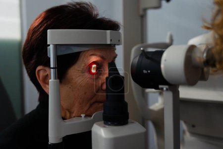 Biomicroscopy machine projecting light on patients eye in a clinic
