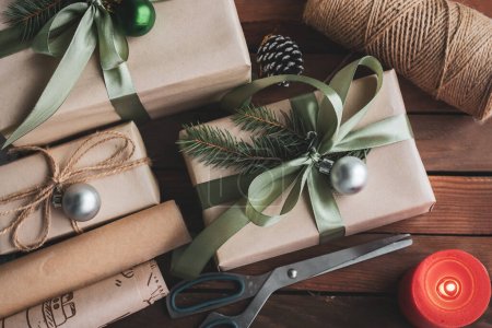 Flat lay composition with Christmas gift boxes and decor on wooden table Poster 623135608