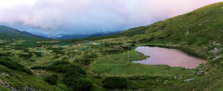 Photo for Lake Nesamovyte in Ukraine. Rhododendron flowers in the Carpathians. Mountain lake. - Royalty Free Image