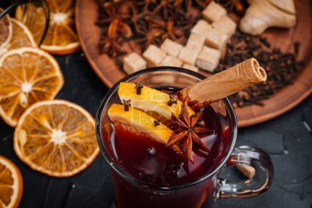 Mulled wine is the main drink of Christmas markets on a dark background. Christmas banner.