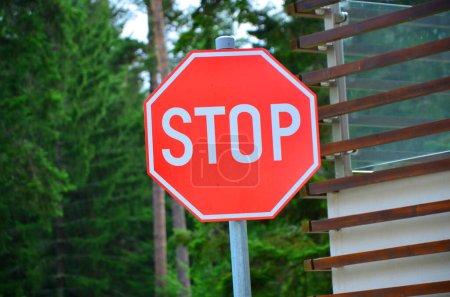 Photo for Red stop sign with trees in background - Royalty Free Image