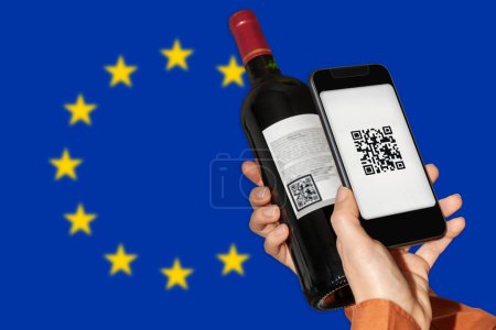 Photo for E-labeling of wine product in EU. Person scans QR code on label of wine bottle using mobile phone in front go flag of European Union. - Royalty Free Image
