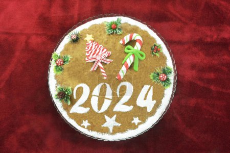 New years cake, known as vasilopita, for 2024  on red velvet tablecloth