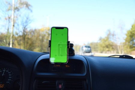 Foto de Smartphone con pantalla verde en soporte de parabrisas en el interior del coche, navegación por carretera y mapas. Foto de alta calidad - Imagen libre de derechos
