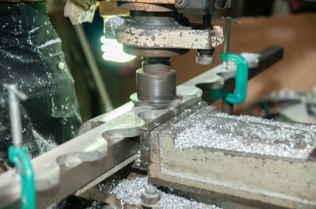 Metallbearbeitung von einer Handfräsmaschine, bei der die Maschine die Oberfläche einer Stahlplatte glättet