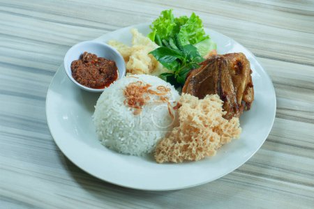 Nasi Bebek Kremes or Crunchy fried duck served with white rice and spicy chili vegetables