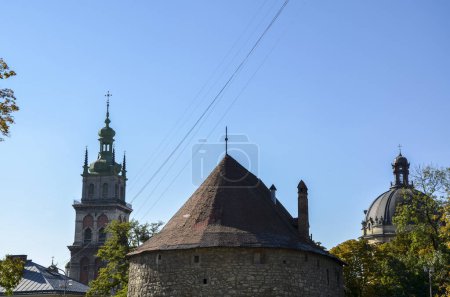 Photo for View to Gunpowder Tower, dome of the Dominican Cathedral, Korniakt Tower of the Assumption Church at the historic center of Lviv, on a sunny autumn day - Royalty Free Image