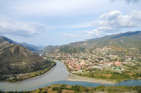 Historic center of the Mtskheta town with vibrant buildings and Svetitskhoveli Cathedral nestled at foot of the mountains at the confluence of the Mtkvari (Kura) and Aragvi rivers. Georgia