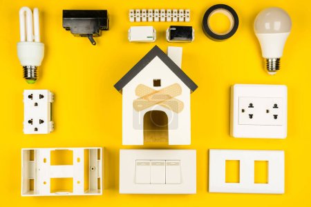 Photo for Different electrician's supplies on yellow background. Background of professional electrician tools with space for text.electrician concept home electrical repair technician. - Royalty Free Image