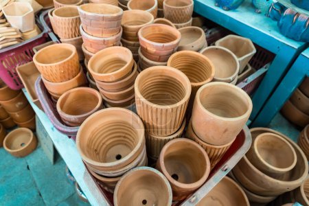 Baked clay flower pot selling in gardening store, gardening equipment, pile of tree pot background