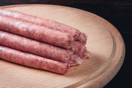 Photo for Sausages in natural casing. Raw BBQ sausages. Thin sausages. Homemade sausages. . High quality photo - Royalty Free Image
