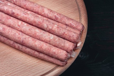 Photo for Homemade sausages. Sausages in natural casing. Raw BBQ sausages. High quality photo - Royalty Free Image