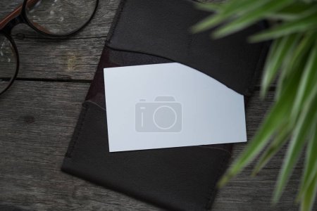 Photo for Name card mockup with card holder on old wooden table background - Royalty Free Image
