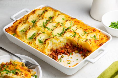 Photo for English Shepherd's pie, or cottage pie, or French version hachis Parmentier. Cooked minced beef meat with vegetables topped with mashed potato and baked. - Royalty Free Image