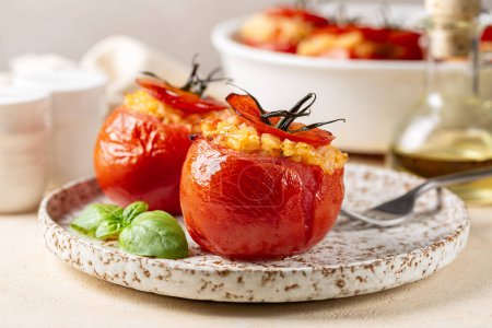 Photo for A plate with baked stuffed tomatoes with rice, cheese and basil. Selective focus, close-up. Mediterranean food. - Royalty Free Image