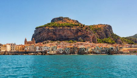 Photo for Olive trees are grown in a costal area of Sicily, agriculture in italy. Beautiful panoramic view of Cefalu town on background, Metropolitan City of Palermo.  August 2023. - Royalty Free Image