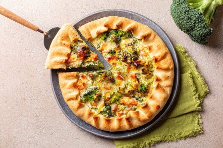 Photo for Homemade savory pie with cream cheese, salmon fish, broccoli and leek. - Royalty Free Image