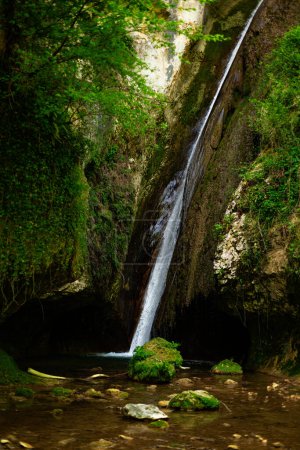 Parco delle Cascate, Italy, natural park in Molina village, Garda lake, Italy. Italian natural park - waterfall cascata dell'orso.  Vertical image.