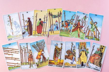 Photo for London, UK: 6 January, 2023: Minor Arcana - Suit of Wands of Tarot Card of Rider Waite deck in hand on pink background - Royalty Free Image