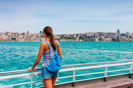 Photo for Young tourist woman in Istanbul. Panorama cityscape of famous tourist destination Bosphorus strait channel. Travel landscape Bosporus, Turkey, Europe and Asia. - Royalty Free Image