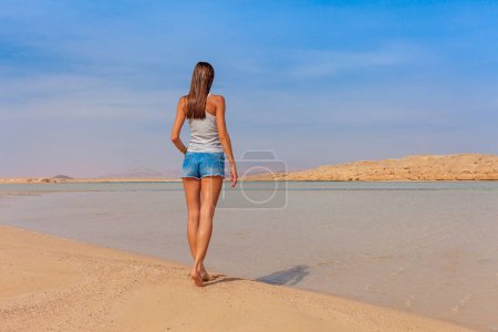Photo for Tourist woman at the Red Sea coast in the Ras Mohammed National Park. Famous travel destionation in desert. Sharm el Sheik, Sinai Peninsula, Egypt. - Royalty Free Image